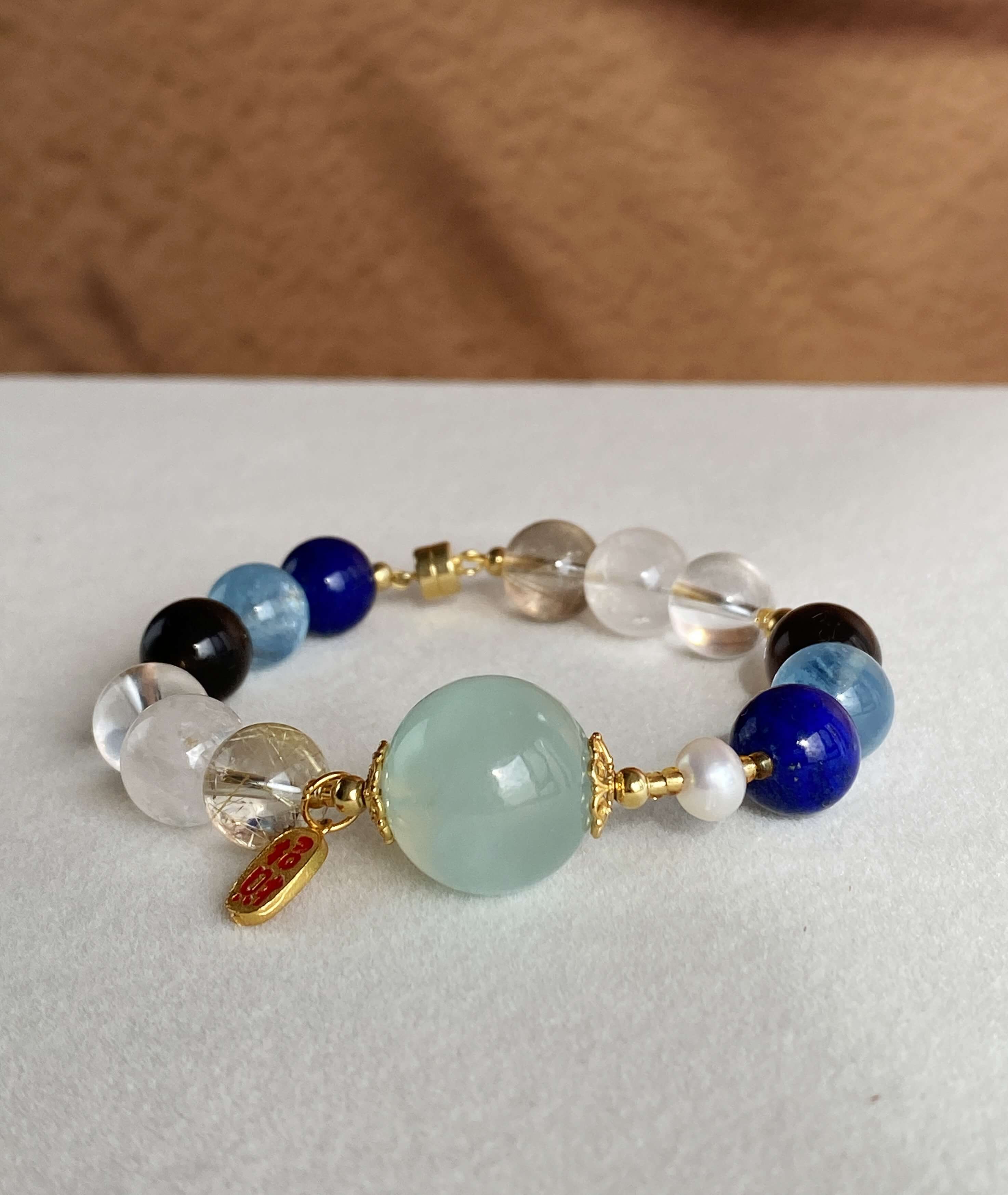 Wisdom Crystal Bracelet Laid out flat, the captivating blue-toned healing stones radiate wisdom and restorative energy